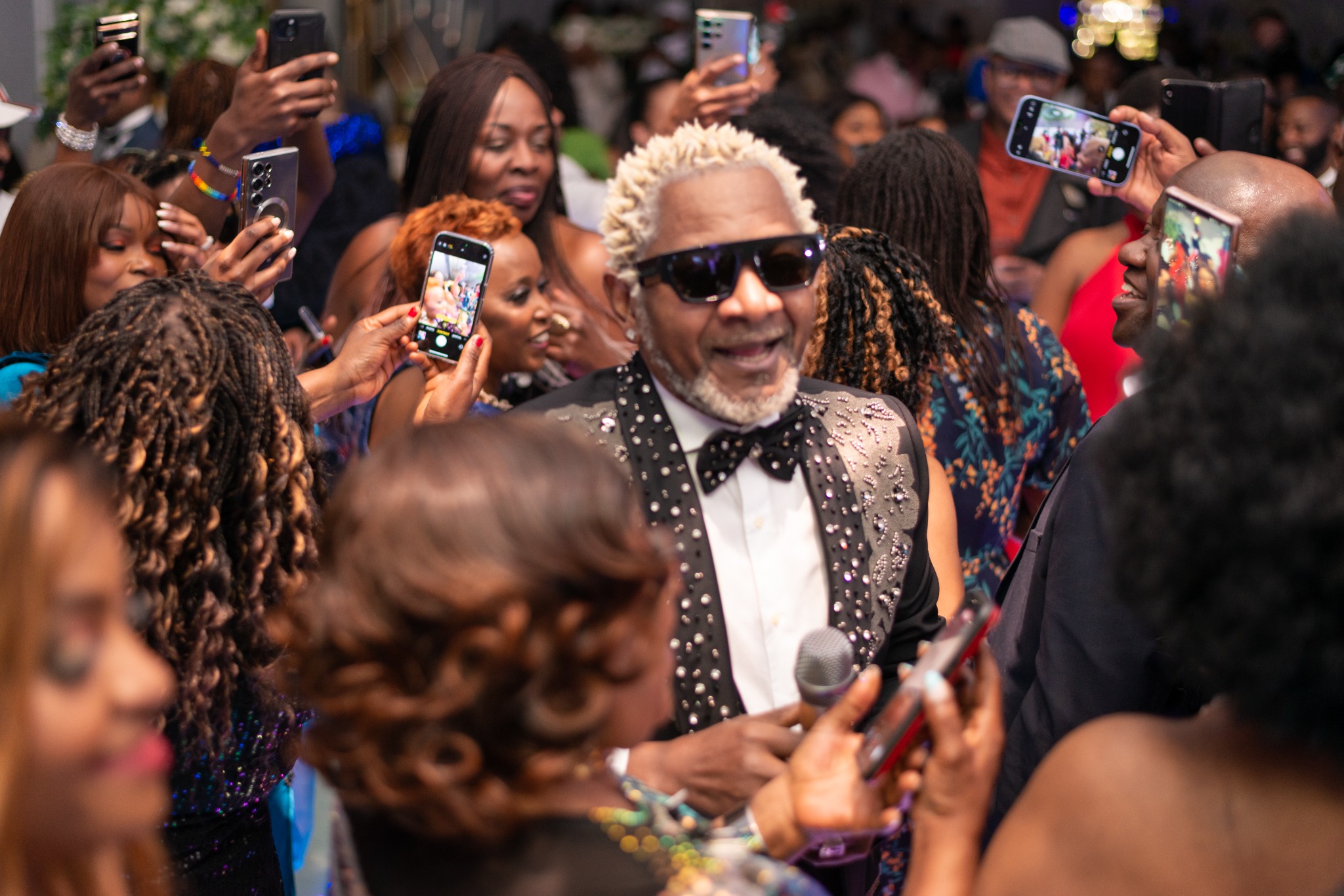A guest enjoying a lively moment in the crowd at the 2024 Grille Community Christmas Gala