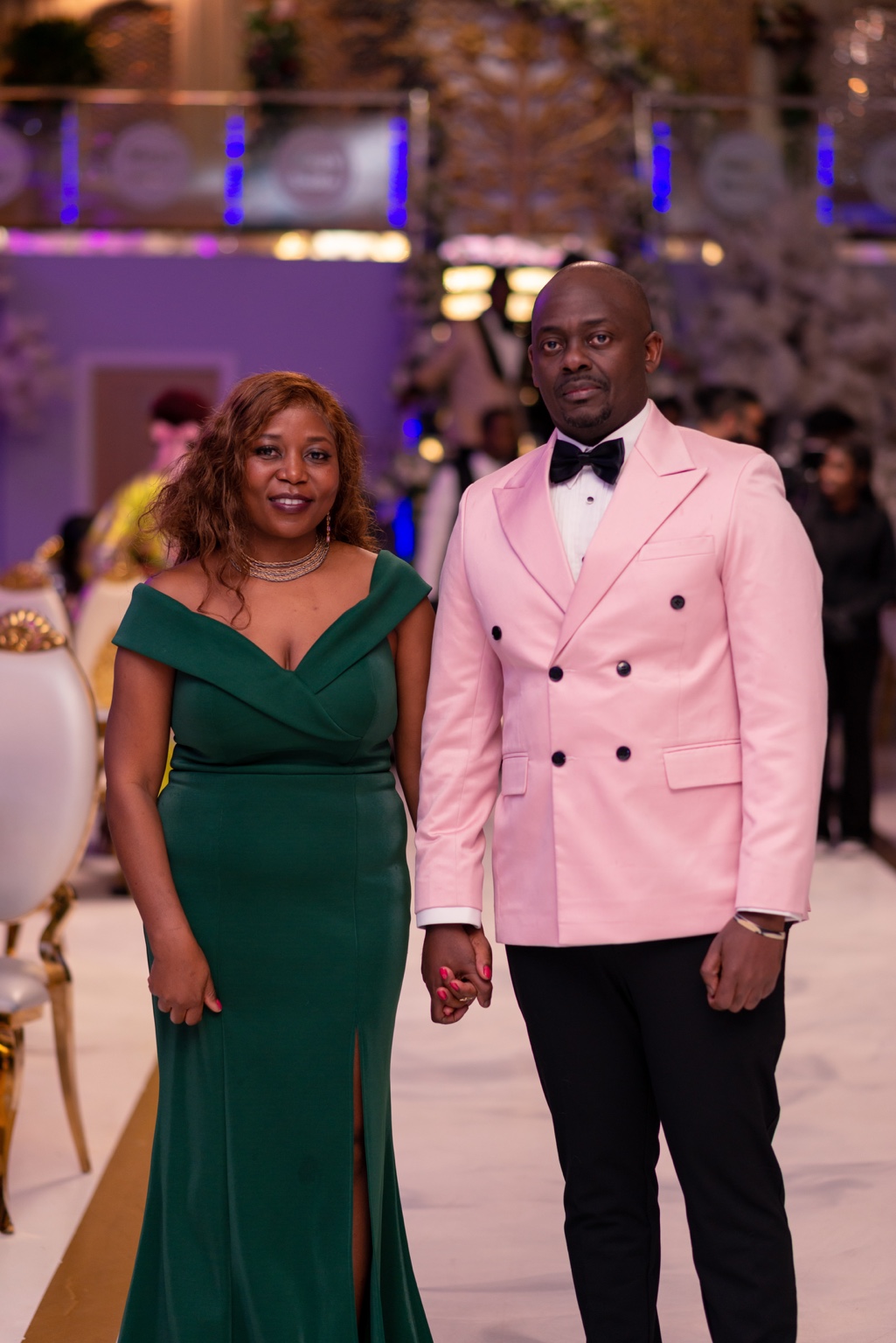 A couple posing in formal evening wear at the 2024 Grille Community Christmas Gala