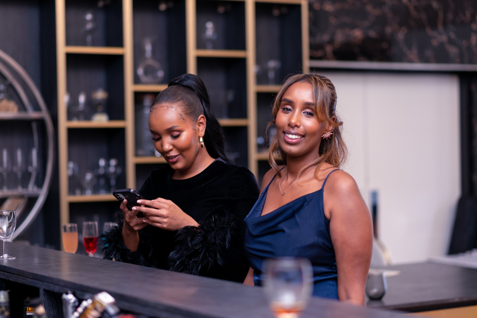 Guests smiling together at the venue bar at the 2024 Grille Community Christmas Gala