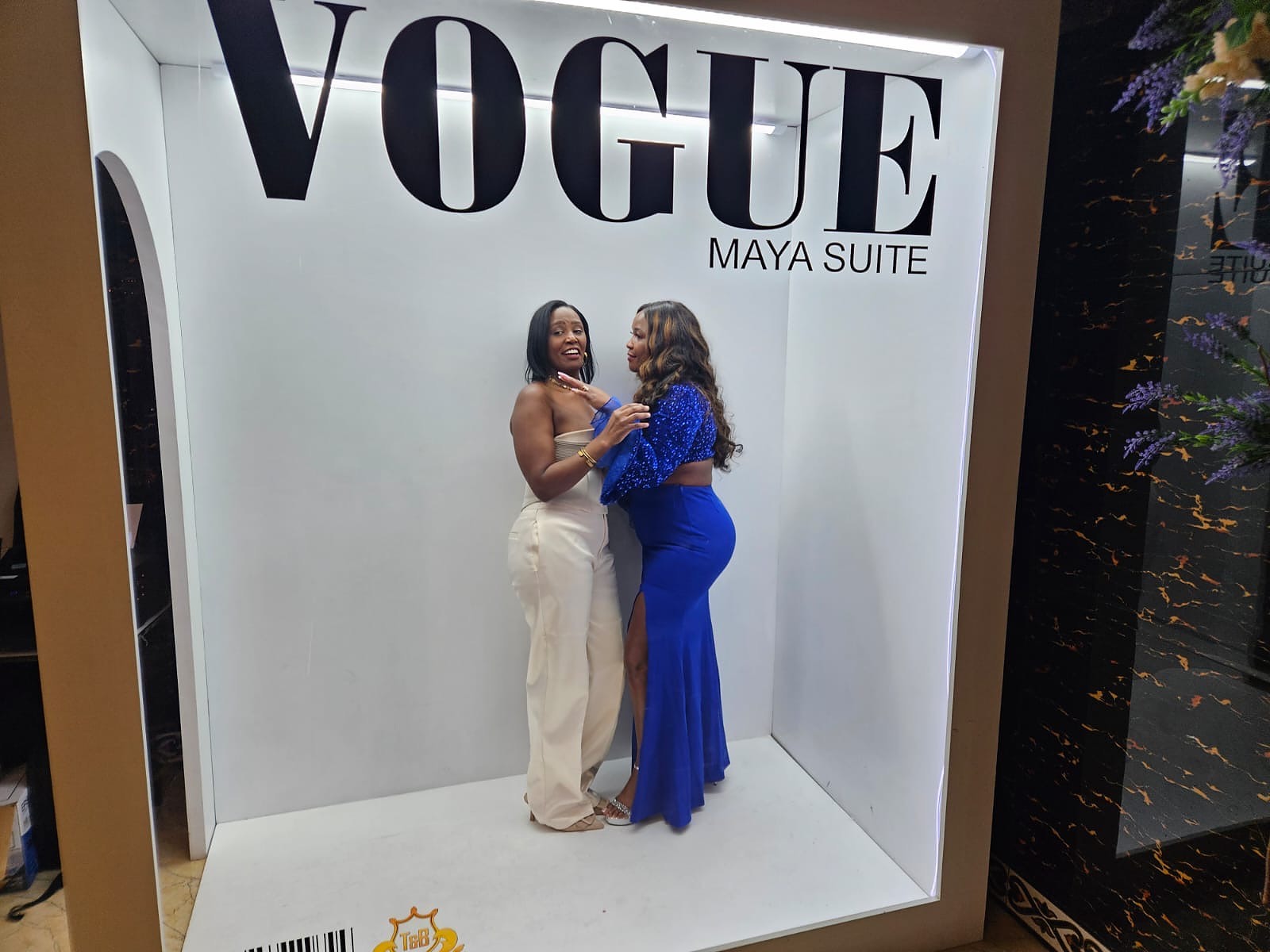 Guests posing inside the Maya Suite Vogue photo area at the 2024 Grille Community Christmas Gala