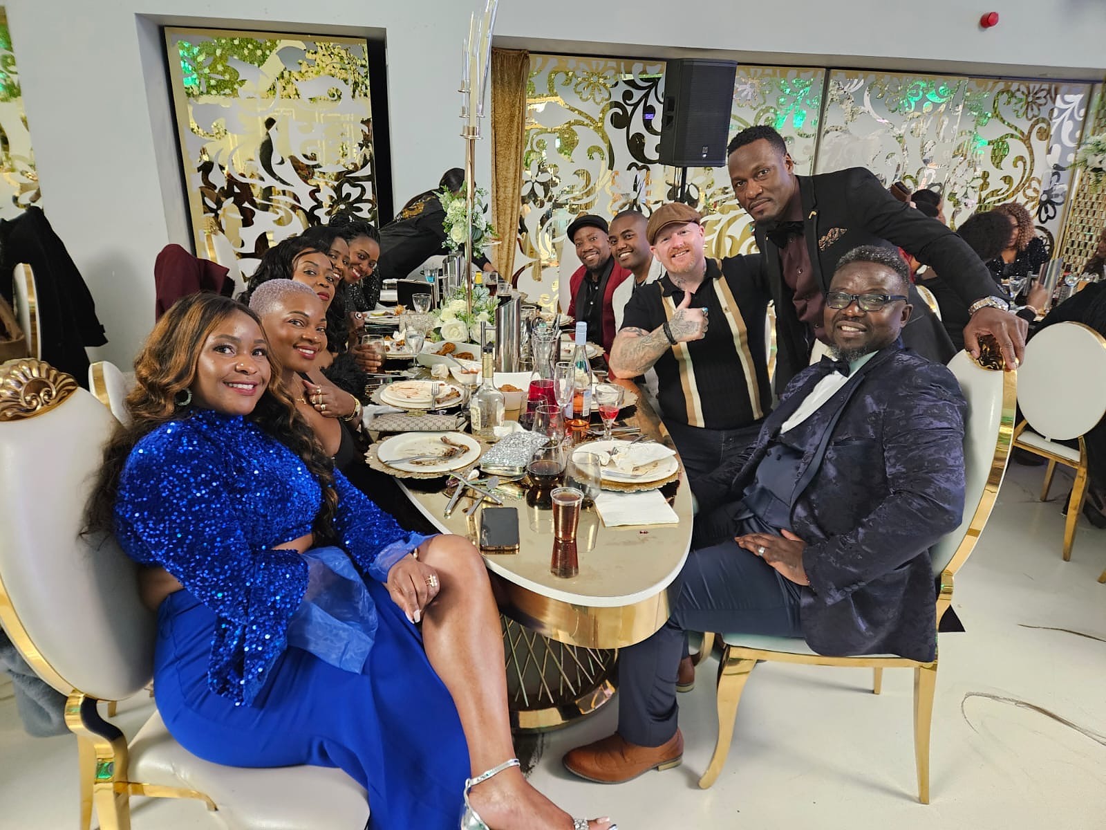 Friends gathered around their dinner table at the 2024 Grille Community Christmas Gala